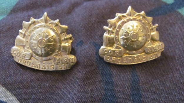 Pair of Irish Army Ordanance collar badges in brass